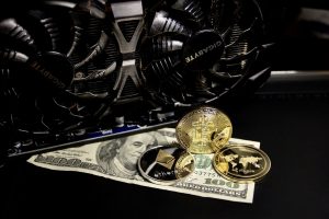 Bitcoin and dollars in propped against graphics card
